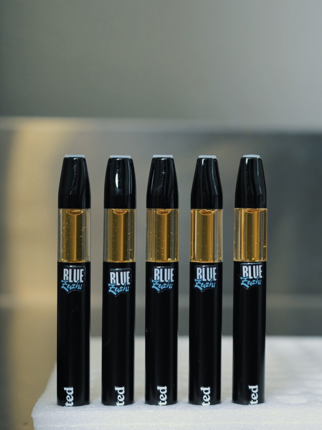 Blue Zushi vape devices filled with distillate
